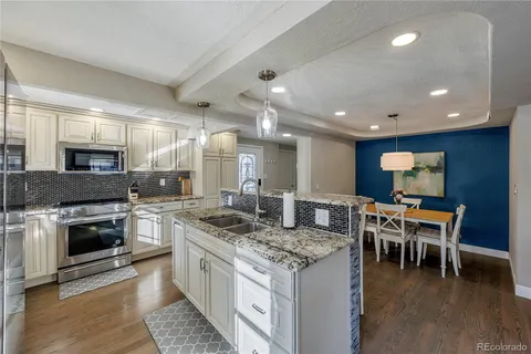 a kitchen with a table chairs microwave and stove