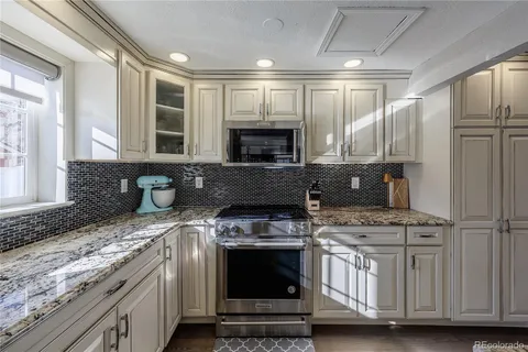 a kitchen with stainless steel appliances granite countertop a stove and a sink