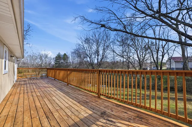 a view of balcony with wooden floor and fence