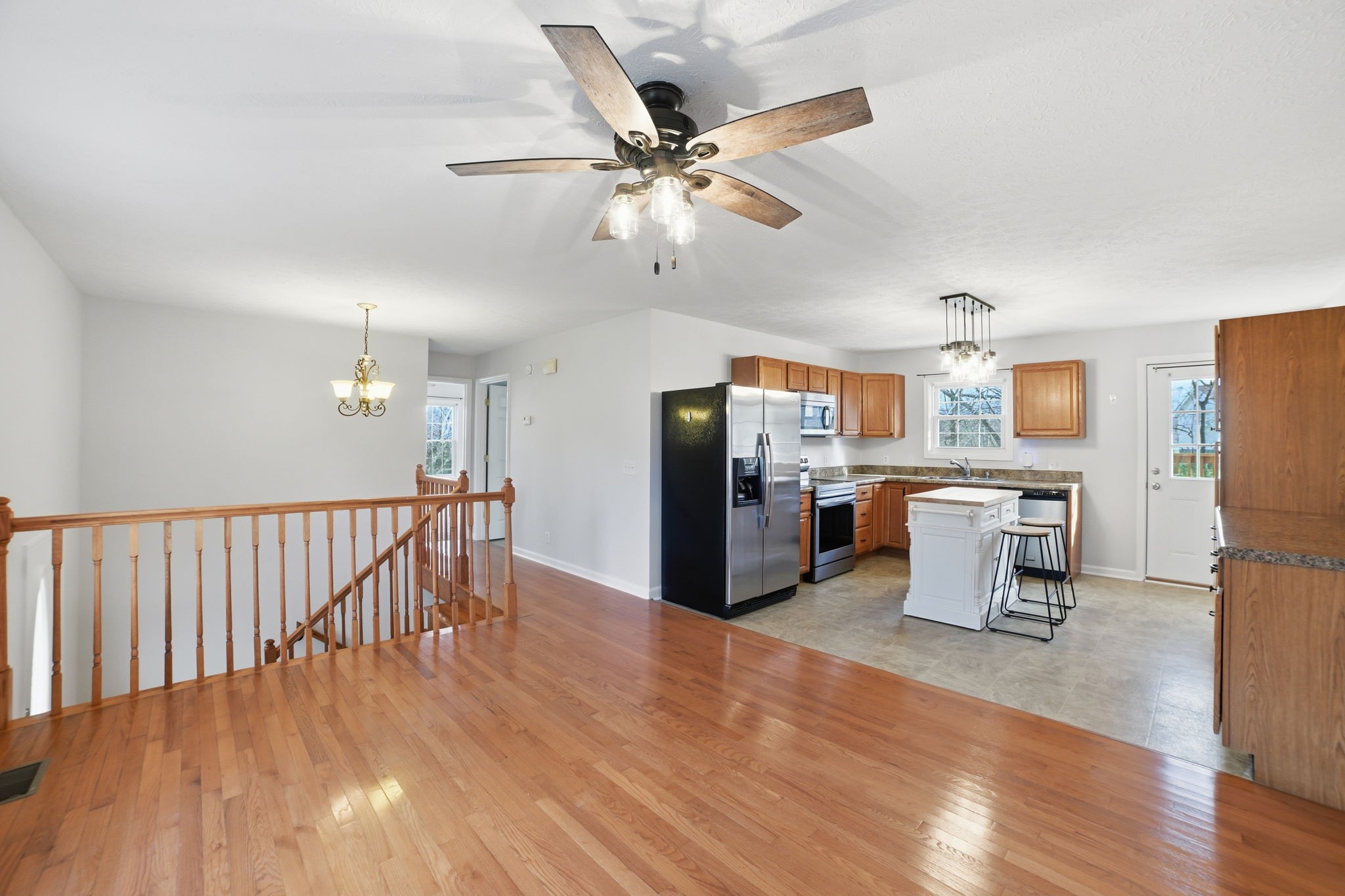 1130 Windsor Circle Lyles, TN 37098 - Photo 6 of 26 a living room with stainless steel appliances kitchen island hardwood floor and a ceiling fan