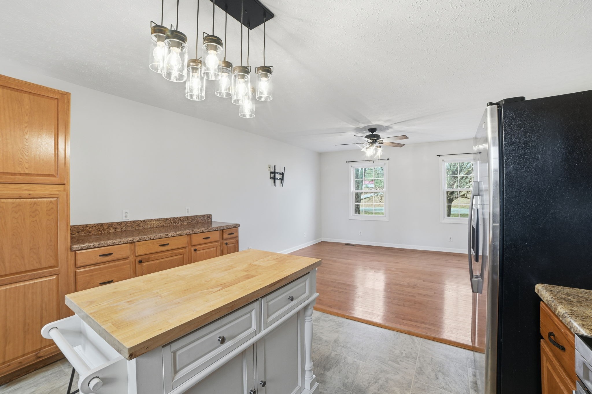 1130 Windsor Circle Lyles, TN 37098 - Photo 8 of 26 a kitchen with stainless steel appliances granite countertop a refrigerator a sink dishwasher a stove and a dining table with wooden floor