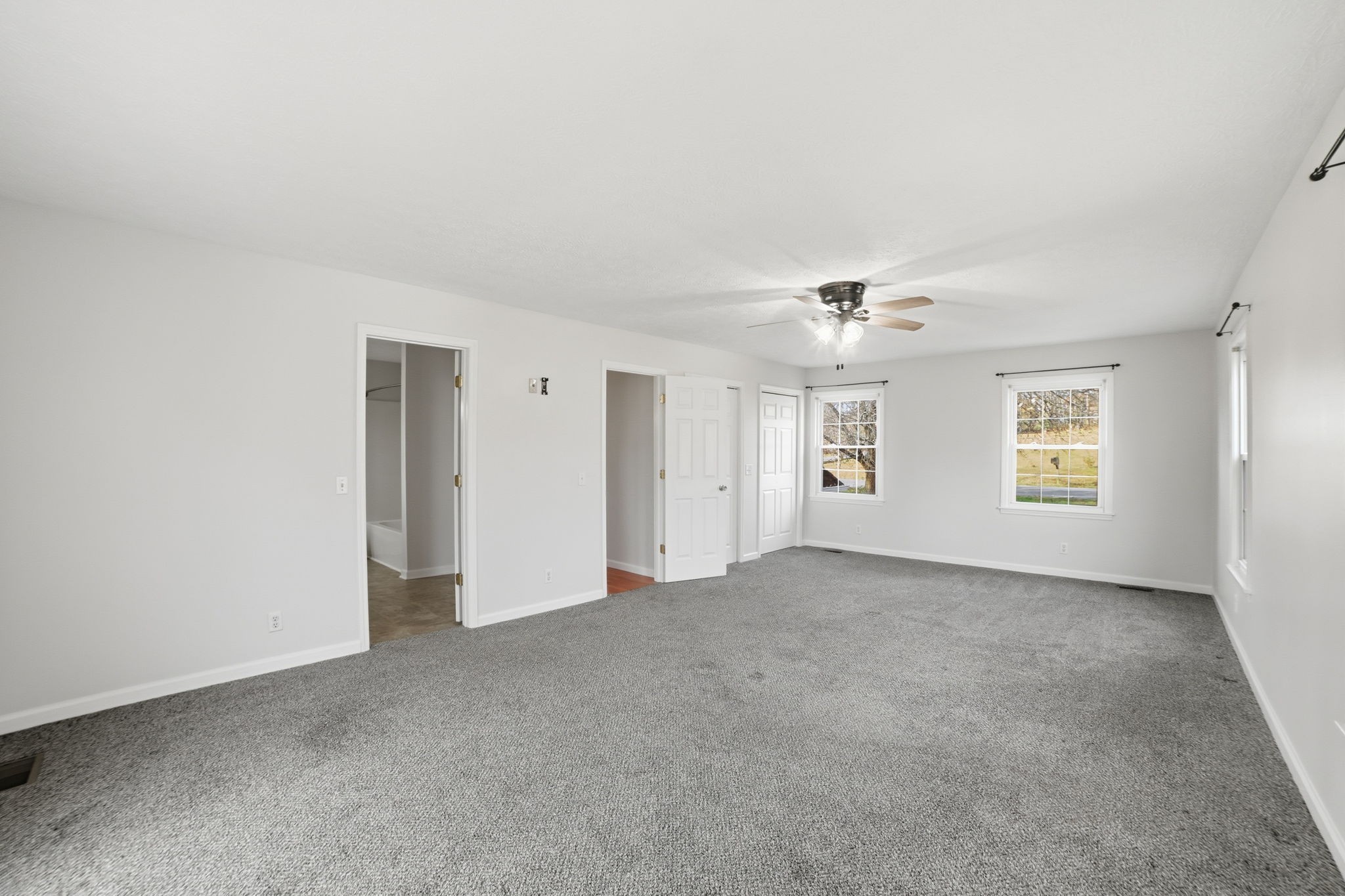 1130 Windsor Circle Lyles, TN 37098 - Photo 10 of 26 an empty room with windows and ceiling fan