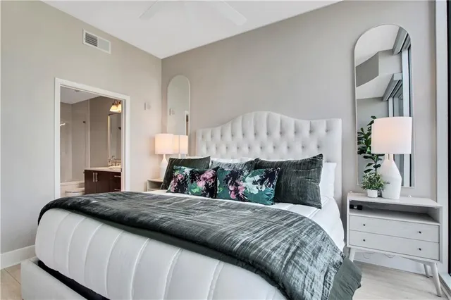 a bedroom with a large bed and a window