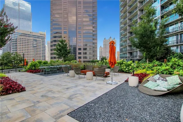 a view of a backyard with sitting area and potted plants