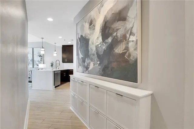 a large white kitchen with a sink and a mirror