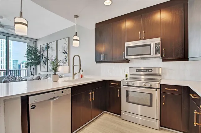 a kitchen with a sink stove and microwave