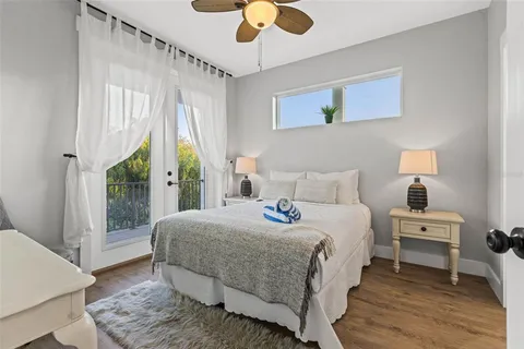 a bedroom with a bed tv and a window