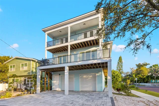 a living room with furniture potted plant and a large window