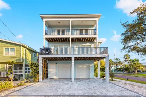 a kitchen with stainless steel appliances granite countertop a dining table chairs refrigerator and cabinets