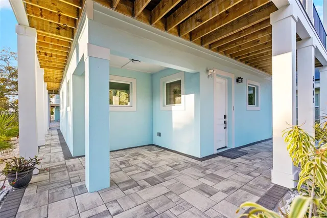 a kitchen with stainless steel appliances granite countertop a white refrigerator a sink dishwasher a dining table and chairs with wooden floor