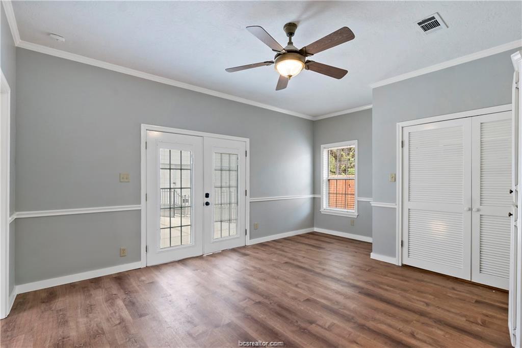 1409 Fannin Street, Unit A Bryan, TX 77803 - Photo 13 of 21 an empty room with wooden floor and windows