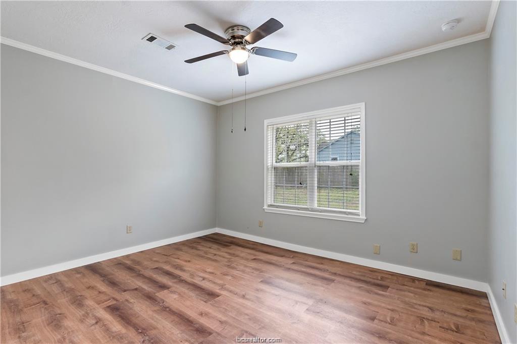 1409 Fannin Street, Unit A Bryan, TX 77803 - Photo 16 of 21 a view of empty room with wooden floor and fan