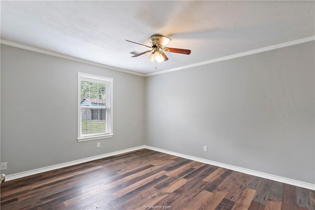 1409 Fannin Street, Unit A Bryan, TX 77803 - Photo 20 of 21 an empty room with wooden floor ceiling fan and windows