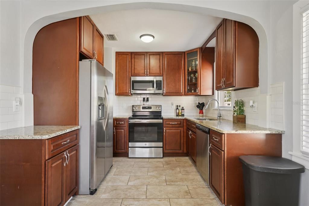 4809 33rd Avenue North St. Petersburg, FL 33713 - Photo 3 of 62 a kitchen with stainless steel appliances granite countertop a refrigerator stove and a sink