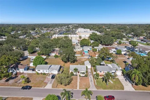 an aerial view of residential houses with city view
