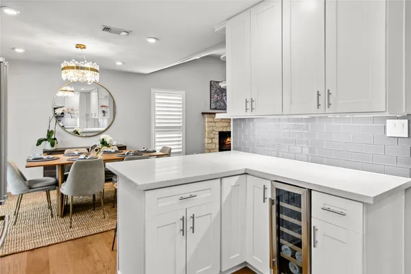 a kitchen with a sink a cabinets and chairs