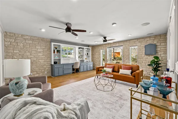 a living room with furniture and a wooden floor