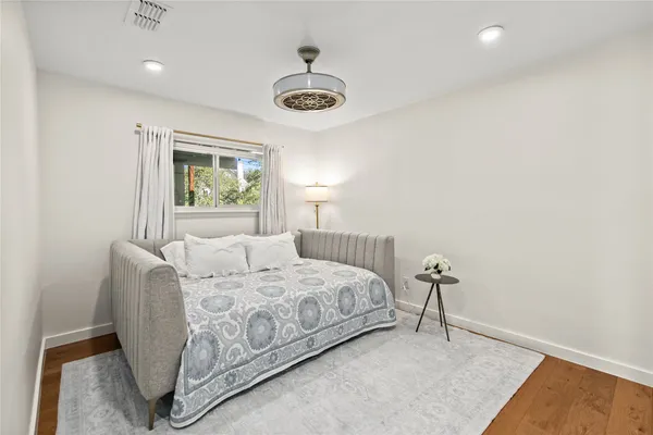 a bedroom with a bed and a chandelier