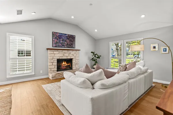 a living room with furniture a window and a fireplace