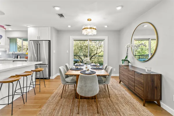 a dining room with furniture a window and wooden floor
