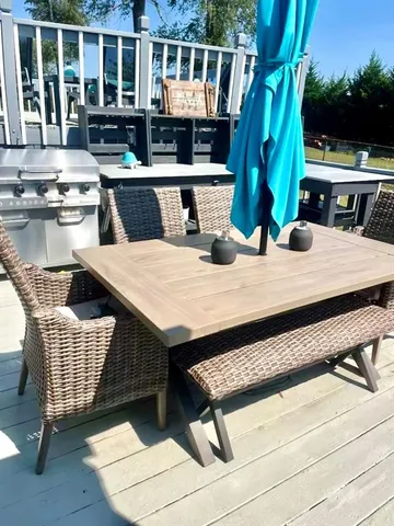 a view of roof deck with wooden floor and seating space