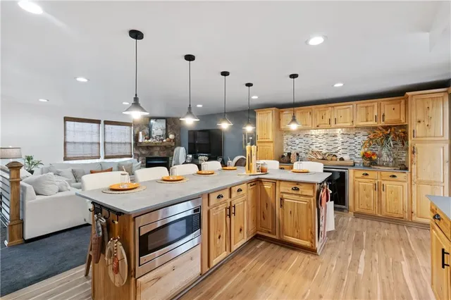 a large kitchen with a table and chairs