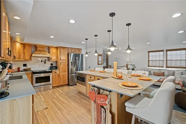 a kitchen with stainless steel appliances a stove sink and cabinets
