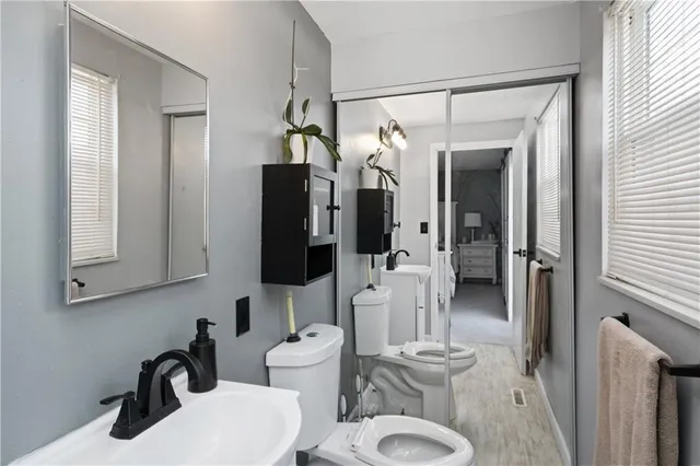 a bathroom with a sink mirror vanity and toilet
