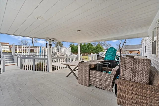 a view of a porch with furniture and garden view