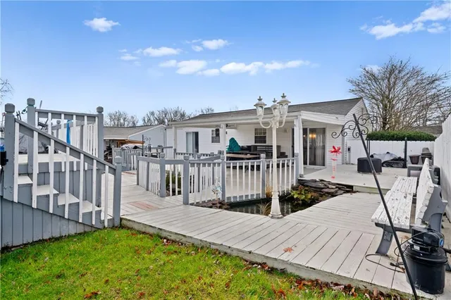 a view of a house with backyard and sitting area