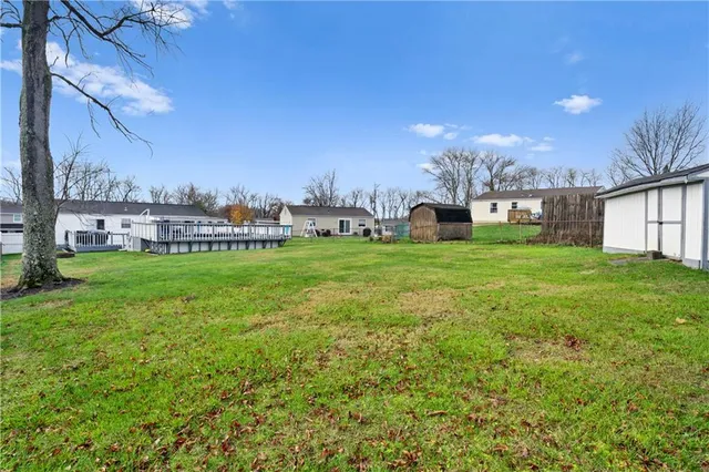 a view of a house with a big yard and potted plants