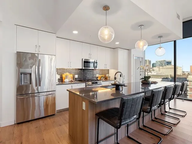 a living room with furniture a chandelier and a flat screen tv