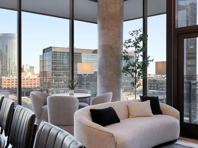 a bedroom with a large window and a walk in closet