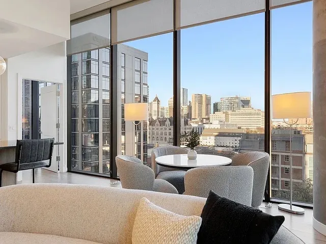 a view of a patio with lawn chairs couches and wooden floor