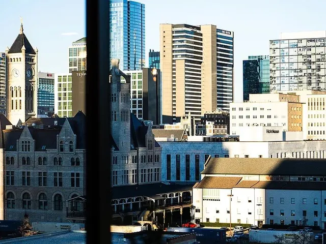 a living room with furniture large window and a view of kitchen