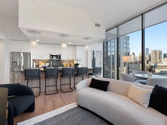 a bedroom with a large bed and a painting on the wall