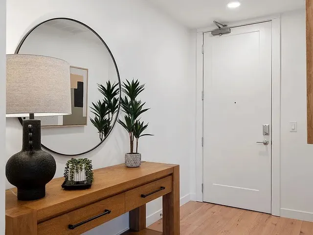 a kitchen with stainless steel appliances granite countertop a refrigerator a stove a sink dishwasher a dining table and chairs with wooden floor