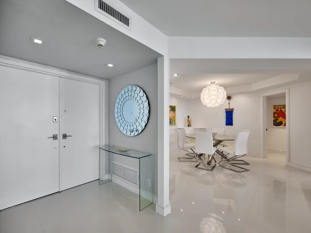 a living room with furniture and floor to ceiling windows