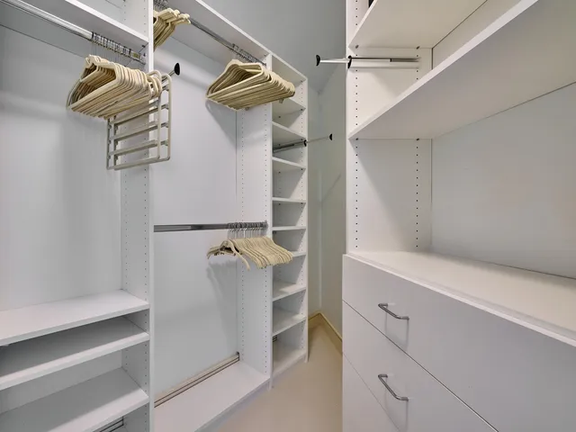 a bathroom with a tub a double vanity sink and mirror