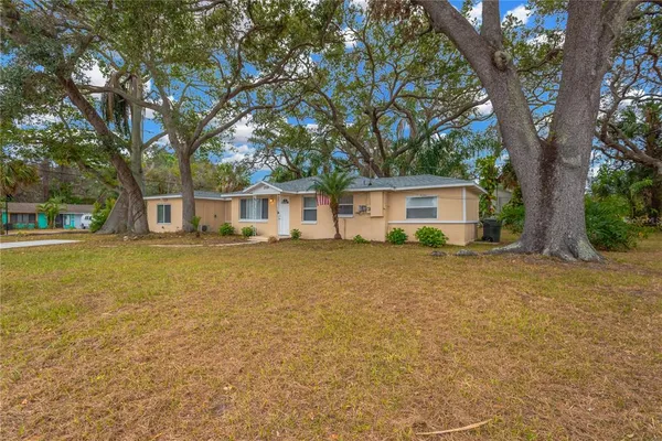 a front view of house with yard and trees