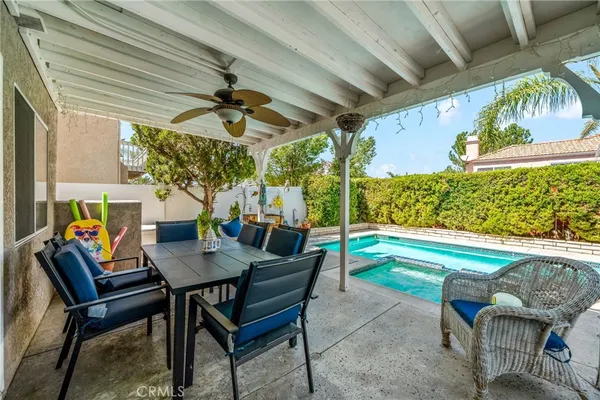 a view of an outdoor dining space with a table and chairs