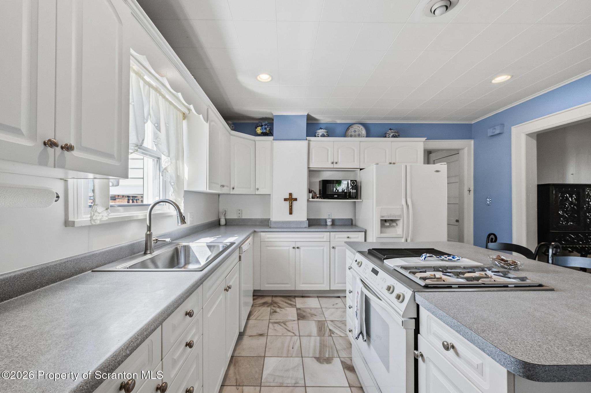 616 Myrtle Street Scranton, PA 18510 - Photo 15 of 65 a kitchen with a sink stove top oven and refrigerator