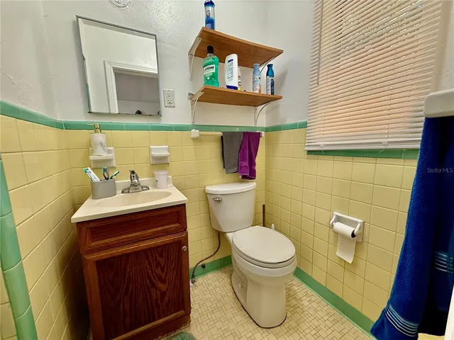 a bathroom with a sink toilet and mirror