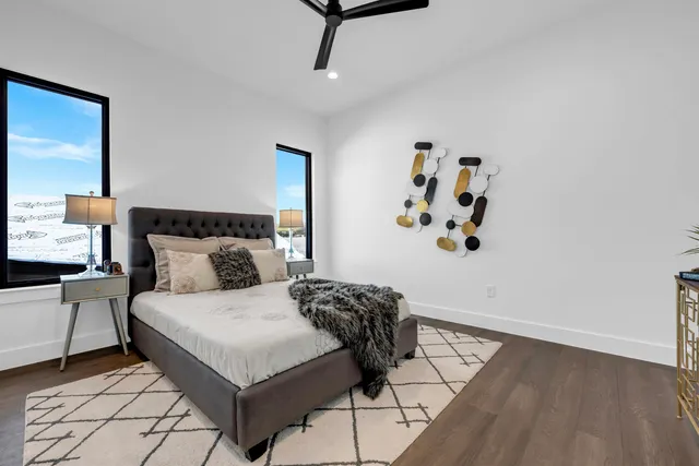 a bedroom with a bed and wooden floor