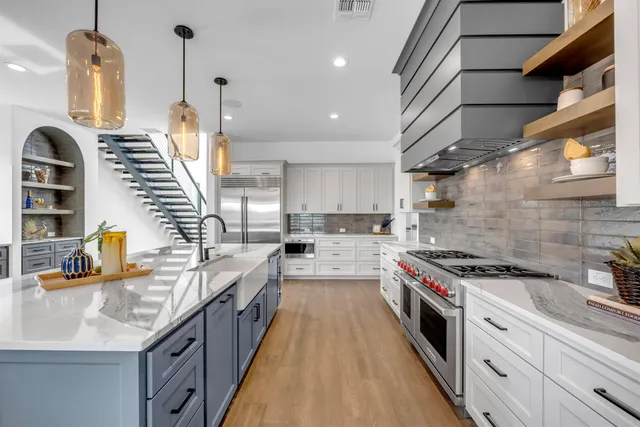 a kitchen with stainless steel appliances granite countertop lots of counter space sink and stove