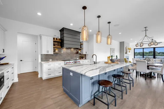 a large kitchen with lots of counter space and sink