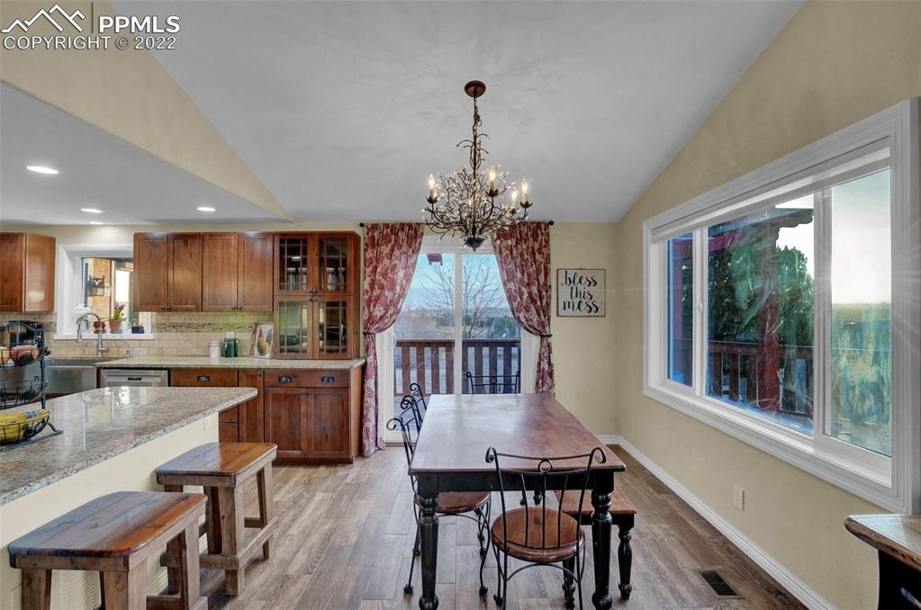 1451 R Street Penrose, CO 81240 - Photo 12 of 50 a dining room with furniture a chandelier and wooden floor