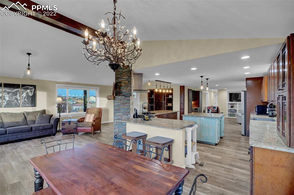 1451 R Street Penrose, CO 81240 - Photo 13 of 50 a living room with furniture a chandelier and a dining room