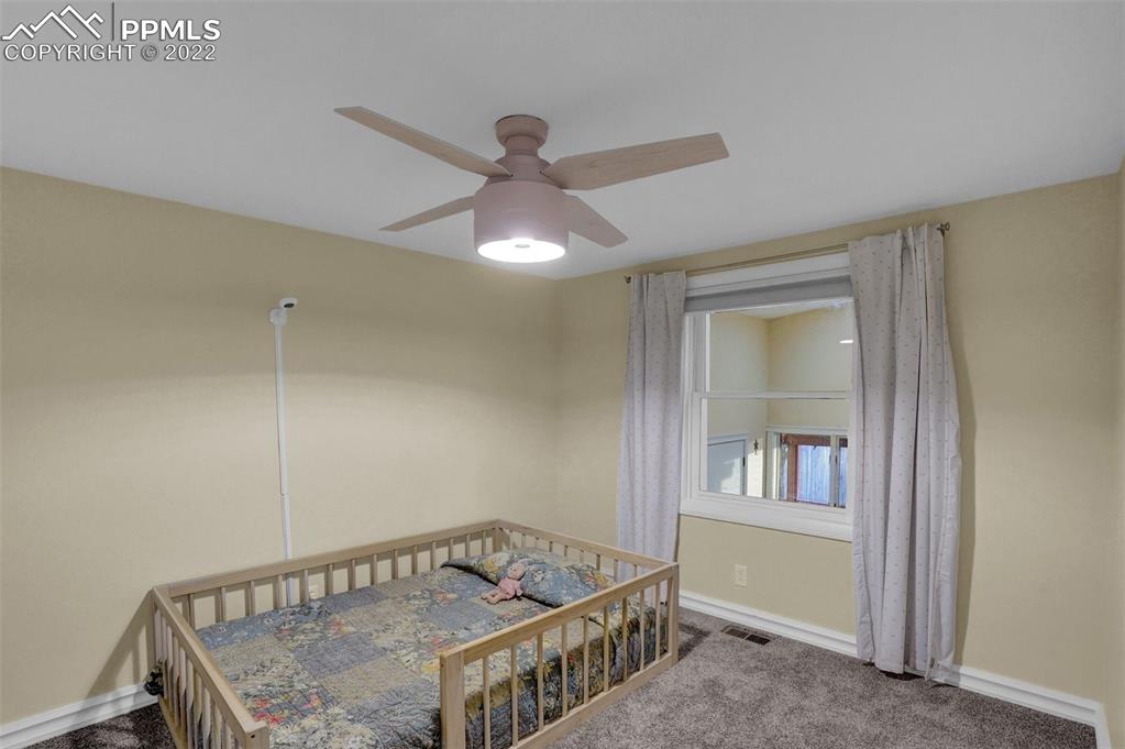 1451 R Street Penrose, CO 81240 - Photo 22 of 50 a bedroom with a bed and a window