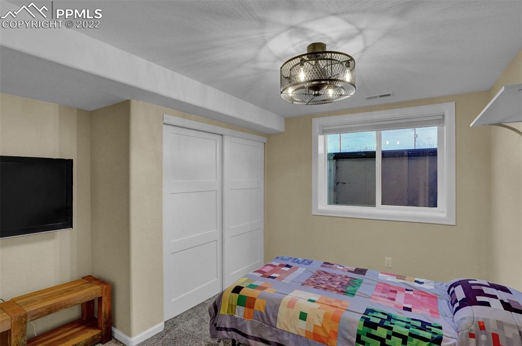 1451 R Street Penrose, CO 81240 - Photo 31 of 50 a bedroom with a bed and a flat tv screen